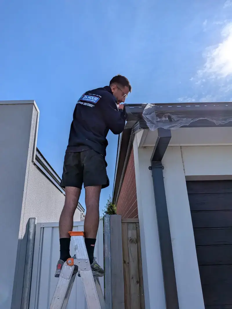 Roof plumber working on gutter in Caulfield